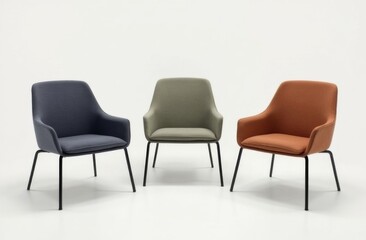 Three modern upholstered chairs in blue, green, and orange fabric finishes with sleek black legs, arranged in a minimalist studio setting