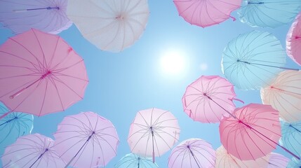 Pastel umbrellas float against a bright sunny sky