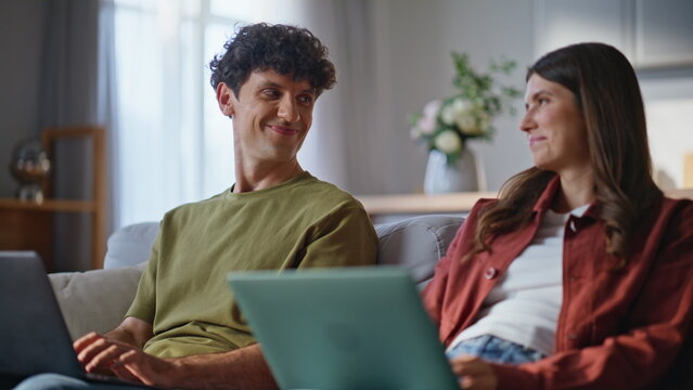 Freelancers couple working laptops at domestic interior closeup. Online family