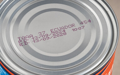 Close-up of 2028 expiration date on canned food. Best before date on aluminium can. Close up view with narrow depth of field. Aluminum tin can