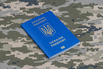 Ukrainian passport, khaki-colored military background, the concept of refugee and immigration...