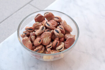 Soaked beans in water in glass bowl on marble table. Food and healthy eating. Protein foods. 