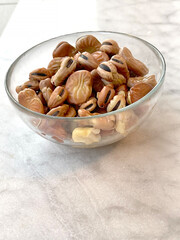 Soaked beans in water in glass bowl on marble table. Food and healthy eating. Protein foods. 