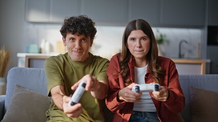 Video players family sitting sofa console at home closeup. Friends losing game