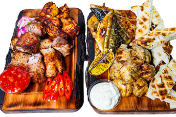 Delicious assortment of grilled meats and breads served on wooden platters