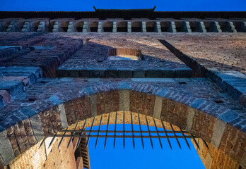 Night view of Castello Sforzesco (Sforza's Castle) a medieval fortification located in Milan, northern Italy.  Details of a gate. It was built in the 15th century by Francesco Sforza, Duke of Milan