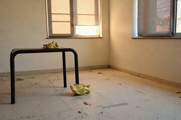  A room with a table and paper crumpled on the floor