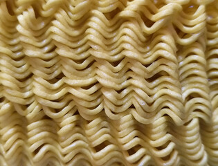 Dry instant noodles. Uncooked ramen noodles. Dry noodle background.