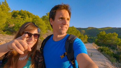 SELFIE: Smiling couple admires beautiful views as they explore island of Hvar during their summer...