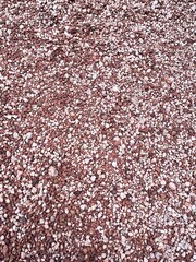Vibrant abstract background of red-colored pebbles, showcasing smooth textures and rich hues. A stunning composition highlighting natural patterns and earthy tones for a bold and artistic visual