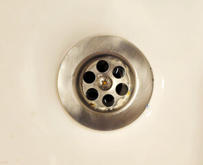Close-up of draining water in a washbasin.
