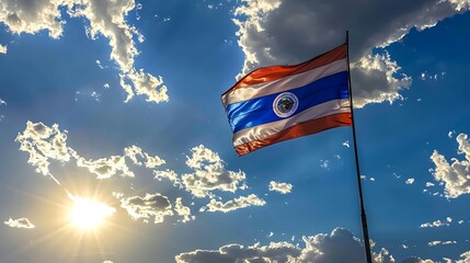 National flag of Paraguay waving in the wind against blue sky.