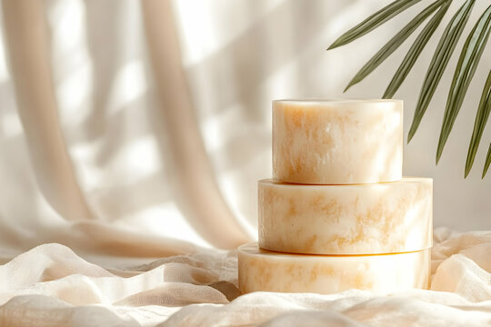 Fototapeta Stacked artisan soap bars on soft fabric with palm leaf shadow, minimalist spa setting.