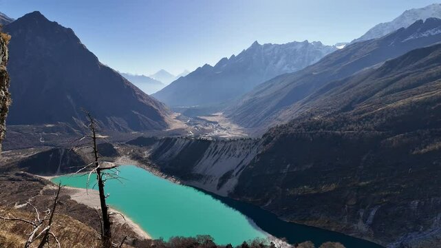 Manaslu, Nepal: Pano of the stunning Birendra Lake and the Manaslu peak and glacier from the Manaslu base camp hike on a sunny winter day in the Himalayas in Nepal