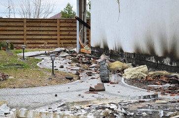 Aftermath of a devastating fire that destroyed a private home. Ruins of the house after the fire,...