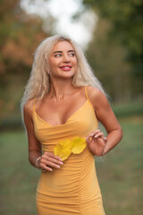 Portrait of a young beautiful blonde girl in nature in summer.