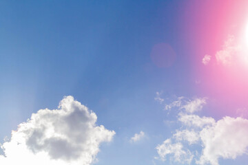 White airy beautiful clouds in a bright blue sky. Clear sunny weather. The concept of environmental safety and cleanliness..