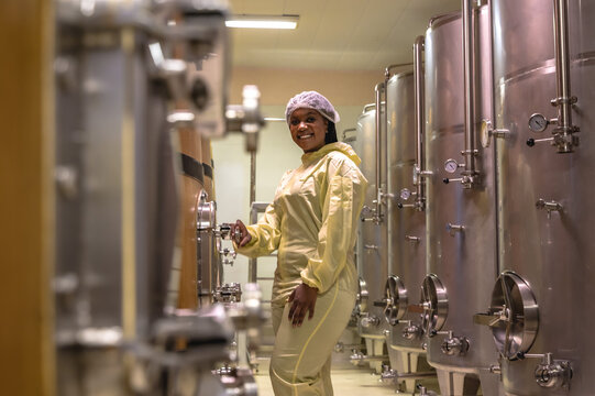 Black wine making woman working in fermentation winery factory
