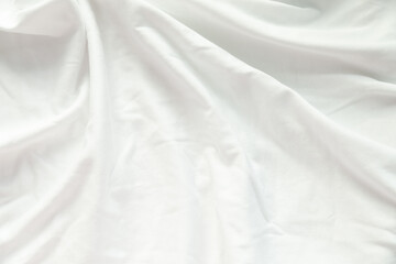 Soft, white fabric with gentle folds and creases.  Perfect for background or texture use.