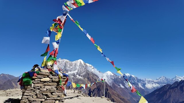Manaslu Base camp, Nepal: Tibetan prayer flags above Sama from the Manaslu base camp day hike along the Manaslu circuit in the Himalaya on a sunny winter day in Nepal