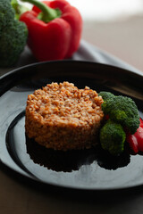 Hearty buckwheat dish served with roasted broccoli and bell peppers. A healthy and delicious meal option.