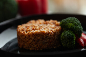 A close-up shot of a delicious buckwheat dish served with steamed broccoli florets.  A healthy and visually appealing meal.