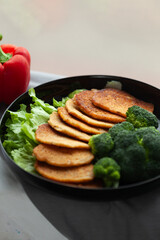 Healthy and delicious meal: savory pancakes served with broccoli and lettuce.