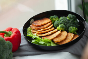 Healthy and delicious meal: savory pancakes served with broccoli and lettuce.