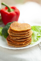 Stack of savory pancakes with vegetables. A healthy and delicious meal or snack.