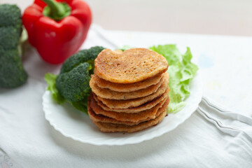 Stack of savory pancakes with broccoli and pepper. Healthy and delicious breakfast or brunch.
