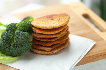 Stack of savory pancakes with fresh broccoli. Healthy and delicious meal or snack.
