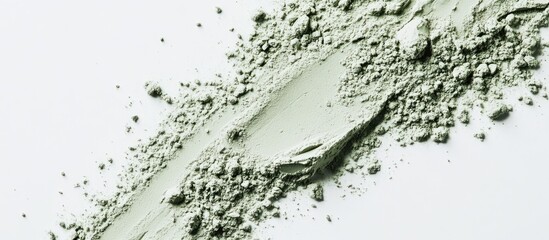 Green cosmetic powder on white background with texture details and uneven distribution, ideal for beauty industry applications and product displays Copy Space