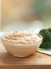 Creamy dip in a glass bowl, served alongside fresh broccoli. Perfect for a healthy and delicious snack or appetizer.