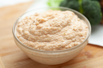 Creamy textured dip in a glass bowl. Perfect for a healthy snack or as a side dish with vegetables.