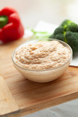 Creamy dip in a glass bowl, ready to be served with vegetables. A healthy and delicious snack or appetizer.