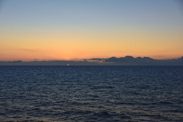 Naklejka premium Nordic Ocean Sunrise of the coast of Norway from boat, Summer 2024, Scandinavia, Europe. 