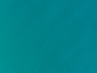 Calm turquoise waters reflecting sunlight with gentle ripples on the surface in a serene coastal environment