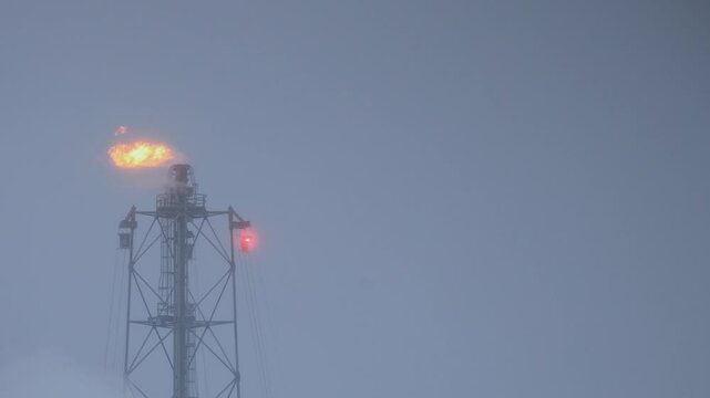 fire hot combustion flame smoke from flare safety technology system burning chemical gas of refinery, petrochemical, chemical plant for produce fuel and power generation from oil industry