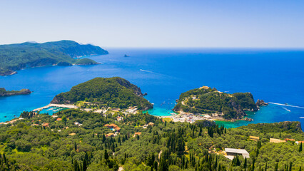 Panoramic view of Paleokastritsa village with azure bays and monastery on top of the hill, Corfu island, Greece © Anyarnia
