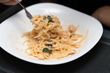 Delicious Italian pasta in a white plate on the table