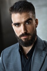 Fototapeta premium Portrait of bearded young businessman looking at camera.