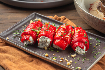 Portion of gourmet stuffed pepper rolls with soft cheese