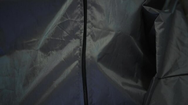 Pathologist zips bodybag with deceased man