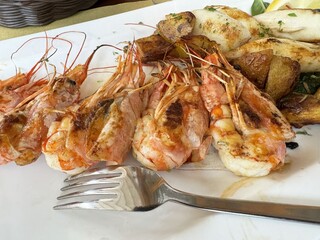 Grilled shrimp and potatoes platter with garlic and herbs