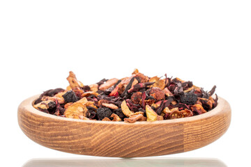 Carpathian forest fragrant tea with wooden utensils, macro, isolated on white background.