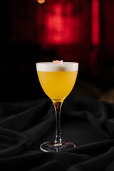 yellow cocktail with foam decorated with a flower