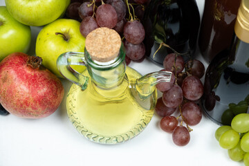 Various fruit vinegars on the background of fruits