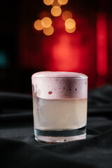 foamy cocktail on black table in night club