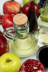 Various fruit vinegars on the background of fruits