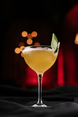mint cocktail on black table in night club